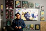 Artist Ryan Worwood poses with his work. Photo by Brent Rowland