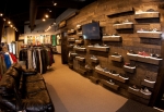 A chill area with a TV mounted to the wall amongst the shoe racks. Photo: Matthew Windsor