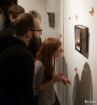 Casey O’Donnell and Jared Christensen appreciate the depth created by torn pages in Pentz’s altered book diorama. “The transparency creates depth that draws you in, but the text on the transparencies brings you back,” he said. Photo: John Barkiple