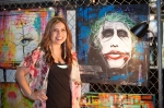 Artist Rocky Fresh poses by her favorite piece. Talking with her about her work, she said that many paintings take multiple months to finish, as nothing is sketched out beforehand.  Photo: Garrett Allen