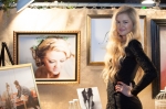 Model Amanda Tomlinson stands in front of the photo taken of her by photographer Lisa Miller. Photo: Garrett Allen