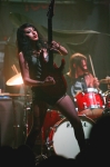Alexia takes her turn at a guitar solo, holding the guitar straight up and down. Photo: Garrett Allen