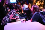 Emma Anzai of Sick Puppies signs a fans chest at the meet and greet in between sets. Photo: Garrett Allen