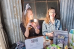 Sammi Branch and Robin Sessions cover the SLUG swag table during the Bunny Hop. SLUG was one of the sponsors for Jesse Walker’s Bunny Hop event. Photo by John Barkiple.