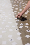 Jenevieve Hubbard, collecting fingerprints from guests of the show and this photographer and adding them in her piece. Photo: Logan Sorenson / LmSorenson.net