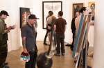Event guest standing perplexed by a piece at Gods, Heroes and Monsters at Studio Elevn. Photo: Logan Sorenson / LmSorenson.net