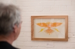 "Thunderbird," a piece by Isaac Hastings being admired by an art exhibit attendee. Photo: Logan Sorenson / LmSorenson.net