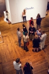 People converse next to the doodle wall, one of the do it exhibits' interactive pieces. Photo: Talyn Sherer