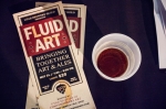 The Fluid Art pamphlet rests on the main table next to the 3 oz. sample cups provided by the featured brewers. Photo: Talyn Sherer