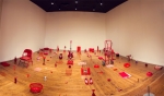 A display hidden in the back showcases the color red on a variety of objects as part of the do it exhibit. Photo: Talyn Sherer