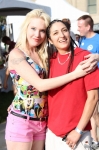 Audrey and Isa cuddle as they stroll along at Utah Pride. Photo by John Barkiple.