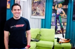 Joey from Geek Tyrant hangs out in his booth, fully-stocked with a couch, game machines and even an Atari with the infamous E.T., ready to torture the daring. Photo: Matt Brunk