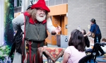 A magician displays his Two Coin Trick to a young, entranced fan. Photo: Matt Brunk