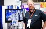 The designer behind Eight Ball Gaming poses with his game, Solius: The Magic Castle. It's an action-platformer game featuring a knight trying to take back a magical castle. Photo: Matt Brunk
