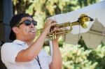 THRIVE!'s trumpet player Dan Herrera rocks the shades in the shade.