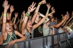 Fans reach their hands in the air hoping to catch some free swag being tossed their way. Photo: Talyn Sherer