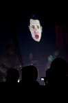 With the band in full swing, still shrouded slightly from the audience, singer Damian Kulash's face is streamed from a live feed, singing over the crowd's heads. Photo: Logan Sorenson / LMSorenson.net