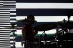 Drummer Dan Konopka playing with a background of two giant projection surfaces that provide a visually stimulating silhouette experience. Photo: Logan Sorenson / LMSorenson.net