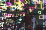 Drummer Dan Konopka backlit with lights, patterns and colors, electrifying the overall experience of an OK Go show. Photo: Logan Sorenson / LMSorenson.net