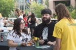 Alana Boscan, Adam Tye and Jon Christiansen gather at the few tables left around at the VIP Patio. Photo: @LmSorenson