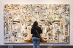 Orchid Behzad examines the intricate details of Ricky Allman Annunciate/Repudiate painting. Photo: Talyn Sherer