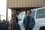 Band members and tour staff set up near the parked vehicles, in view of the audience on the otherside of the fence. Photo: Logan Sorenson @LMSorenson