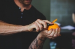 An orange is peeled in preparation for a perfect Manhattan courtesy of Jack Rabbit Gin. Photo: Talyn Sherer