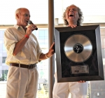 Steve Williams is delighted to receive a platinum album award from John Green. Photo by Scott Frederick