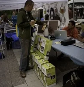 Patrons at Craft Lake City speaking with each other at an artist booth.