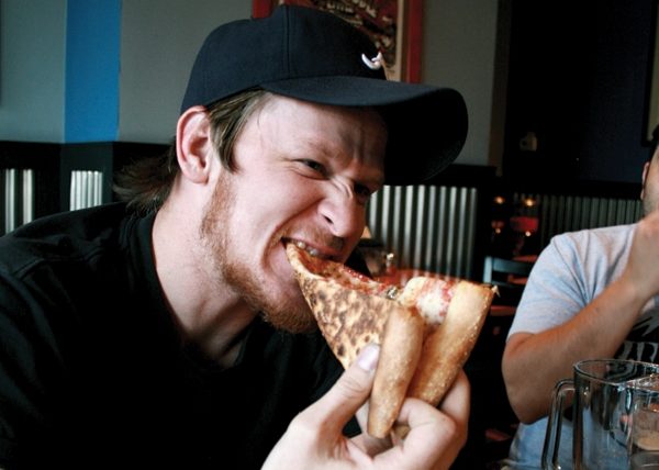 Wes O'Keefe enjoys a slice at Este Downtown.