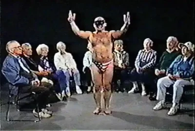Frank Pacholski wearing an American flag Speedo and a cat half-mask.