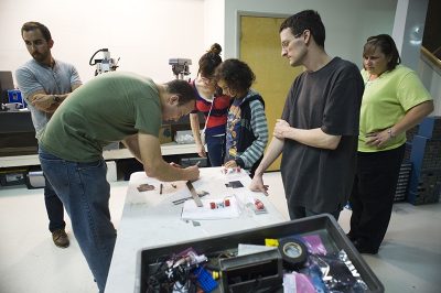 “You’ll want them as low to the ground as you can go, so they don’t tip over during the fight. They’re powered by this little motor and two wheels, and they’ll move in a straight line to push out their opponents.”