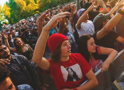 As Bishop Nehru gets ready to crush the mic, the fans raise their hands to hype each other up.