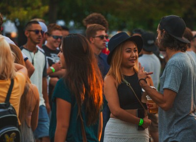 A few friends talk to one another while simultaneously enjoying some local brew.