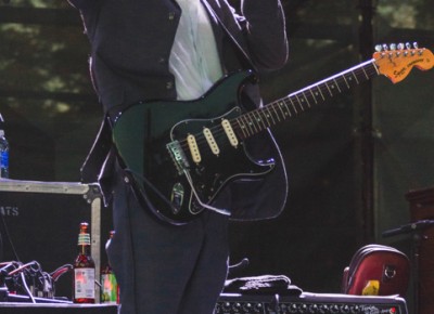 Prhymes guitarist raises his fist in the air as he sips back on a Goose IPA.