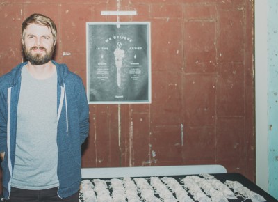 Matt Wigham, who started Big Cartel, stands near goodie bags featuring pins in the shape of a van. Photo: @clancycoop