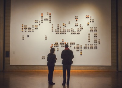 The cryptic message written on the wall awaits deciphering as a couple gazes in wonder. Photo: Talyn Sherer