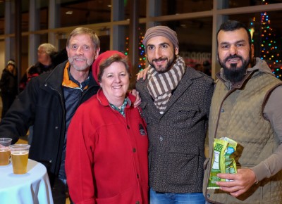 (L-R) Bob Plachta, Nancy Carlson, Omar Abou-Ismail and Sam Aziz take a break from the chilly plaza for beers and snacks upstairs at the Gallivan Center. PopArt Popcorn offered seven flavors at a popcorn bar. Learn more at the popartsnacks.com website. Photo: John Barkiple