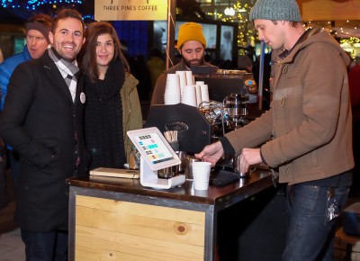 (L-R) Chase Murdock and Stephanie Petry order coffee from Nick Bryce at the Three Pines Coffee booth at KRCL’s 2015 Polar Jubilee. Photo: John Barkiple