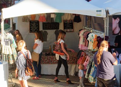 Shoppers browse Hum Stitchery's booth. The shop specializes in children's clothing. Photo: @snowlenda