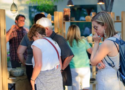 Customers look over ceramic pieces by Joshua Flicker. Photo: @snowlenda