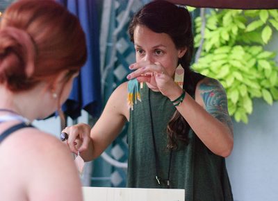 Trish Henderson of Handmadewarrior shows a customer two different earrings for consideration at this year's Craft Lake City DIY Festival. Photo: @snowlenda