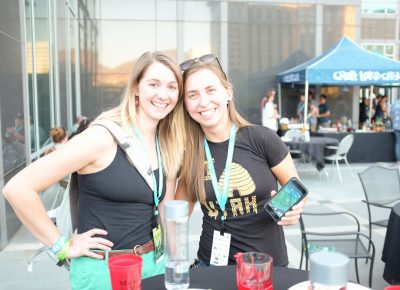 (L–R) Chelsea Naughton and Mallory Millington (level 3) play Pokémon Go! from the VIP Patio. They have their eyes on the red gym at Modern Irrigation. Photo: John Barkiple