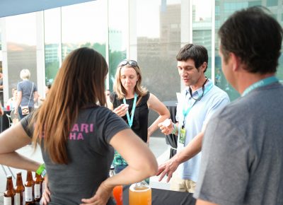 (L–R) Sophia Nicholas and Paul Abate try some Mamachari Kombucha samples. Nicholas prefers the Jasmine Rose flavor. Photo: John Barkiple