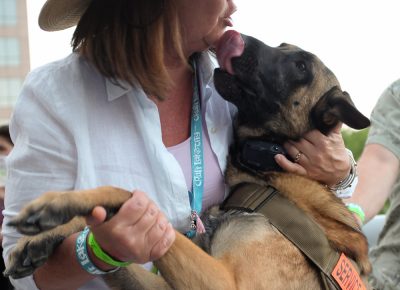 (L–R) Trisha and Zeus smooched in the shade of the Wells Fargo building on the VIP Patio, overlooking the Craft Lake City DIY Festival. Photo: John Barkiple