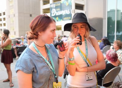 (L–R) Mandy sniffs Bitters Lab cedar and currant bitters while Kelsie takes a whiff of Bitters Lab aromatic bitters. They both love their mixologist, Natalie from Finca. Photo: John Barkiple