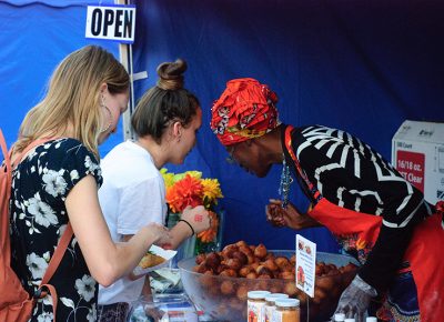 Cathy Tshilombo-Lokemba, known as Mama Africa, talks beigniets with Ashley Statt (center). Photo: @snowlenda