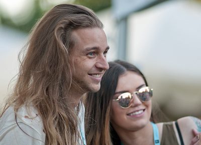 Mitchell Crogan and Paige Hoffman laughing it up with friends before Jenny Lewis. Photo: Scott Frederick