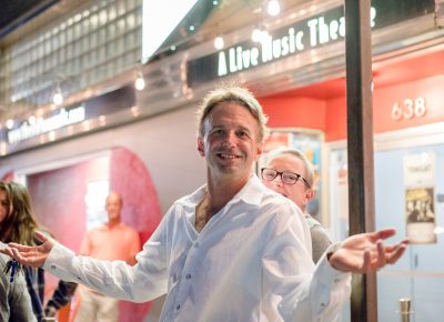 Brian Kelm gets photobombed by Sue Simpson. Good fun and good vibes were at The California Honeydrops' show. Photo: JoSavagePhotography.com