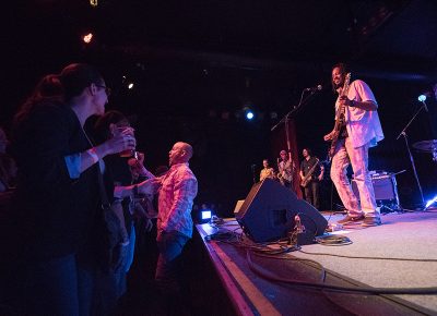 Black Joe Lewis laughs during his performance as a guy takes a selfie of himself and BJL “hanging out.” Photo: JoSavagePhotography.com